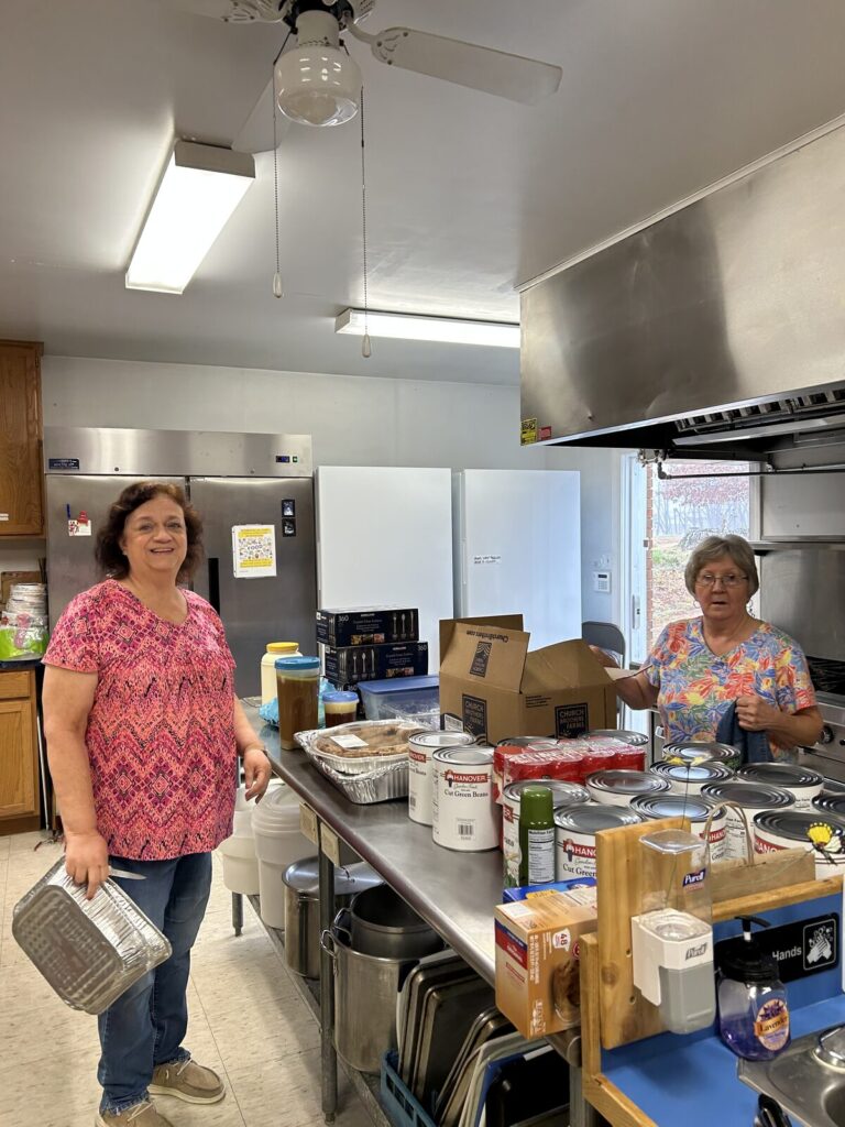 Two volunteers working in the Union Chapel church kitchen