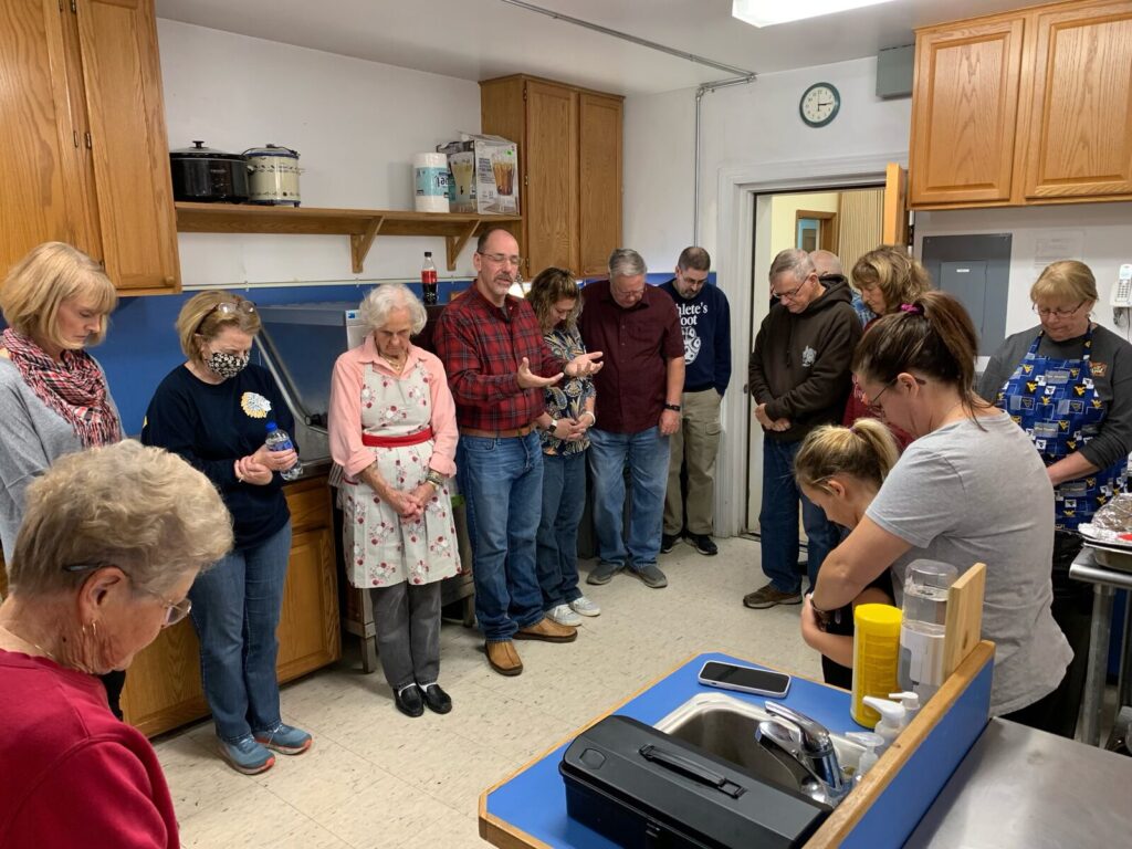 Group of kitchen volunteers gathered in the church kitchen