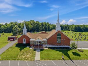 Church exterior with steeples and front lawn